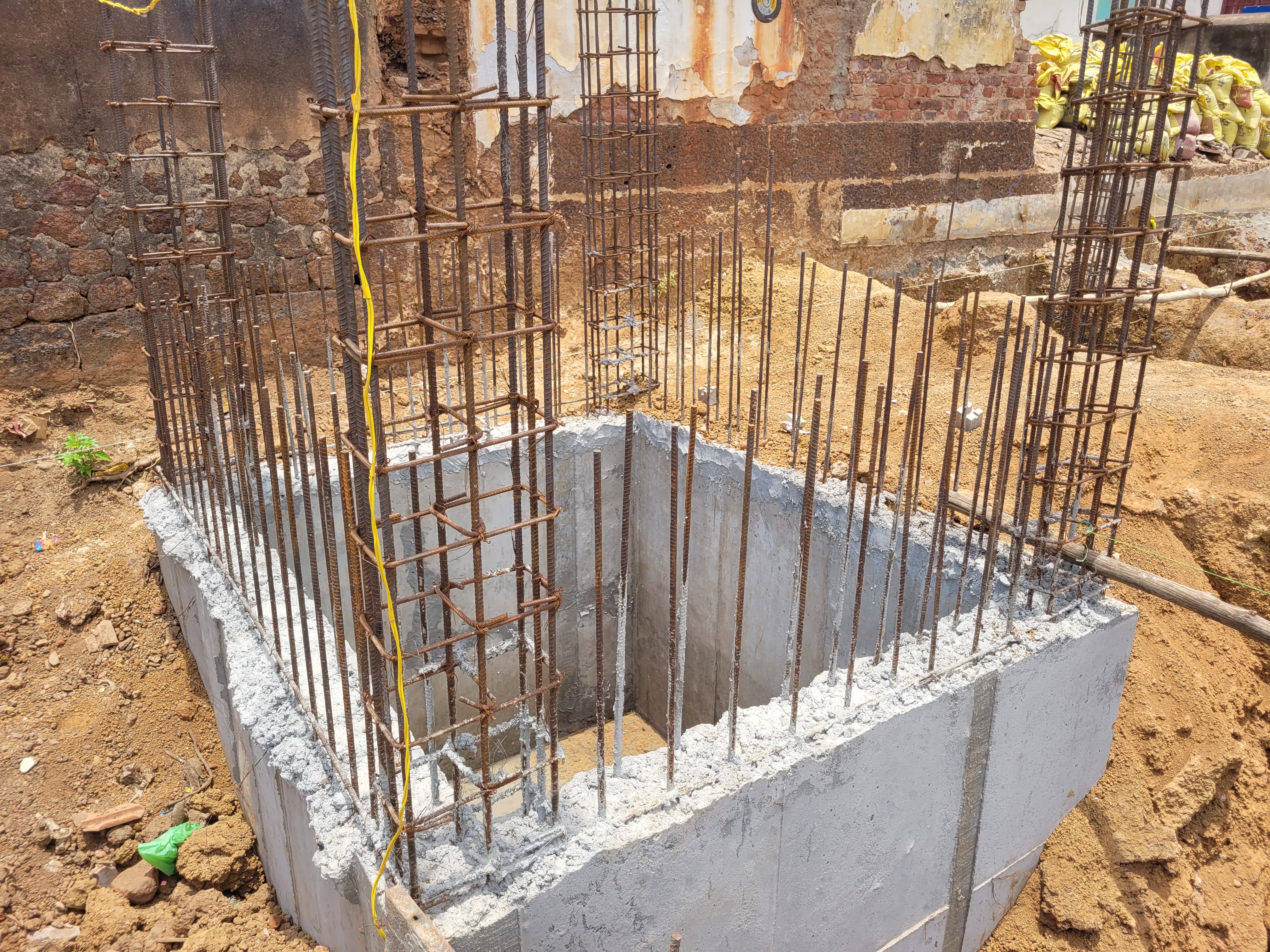 Karupar Sai Residency — foundation footing close-up, April 2026